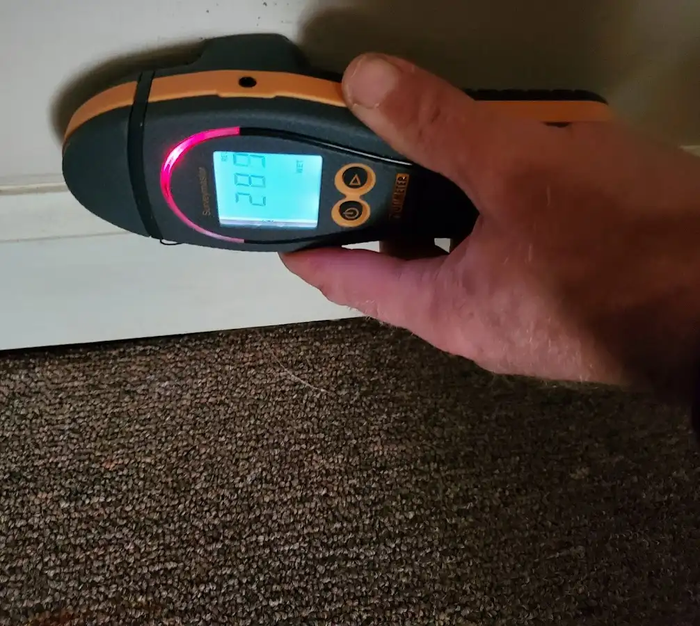 Moisture detection at baseboard during Storm Damage Restoration in Wade Hampton
